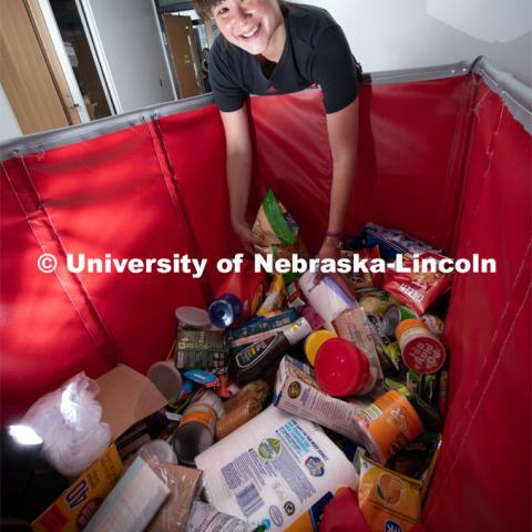 Justina Clark, Director of Undergraduate Research delivers donated items to the Husker Pantry. Her basket of products came from students in the Nebraska Summer Research Program The pantry and Money Management Center have moved from the Nebraska Union to the University Health Center. August 8, 2019, Photo by Gregory Nathan / University Communication.